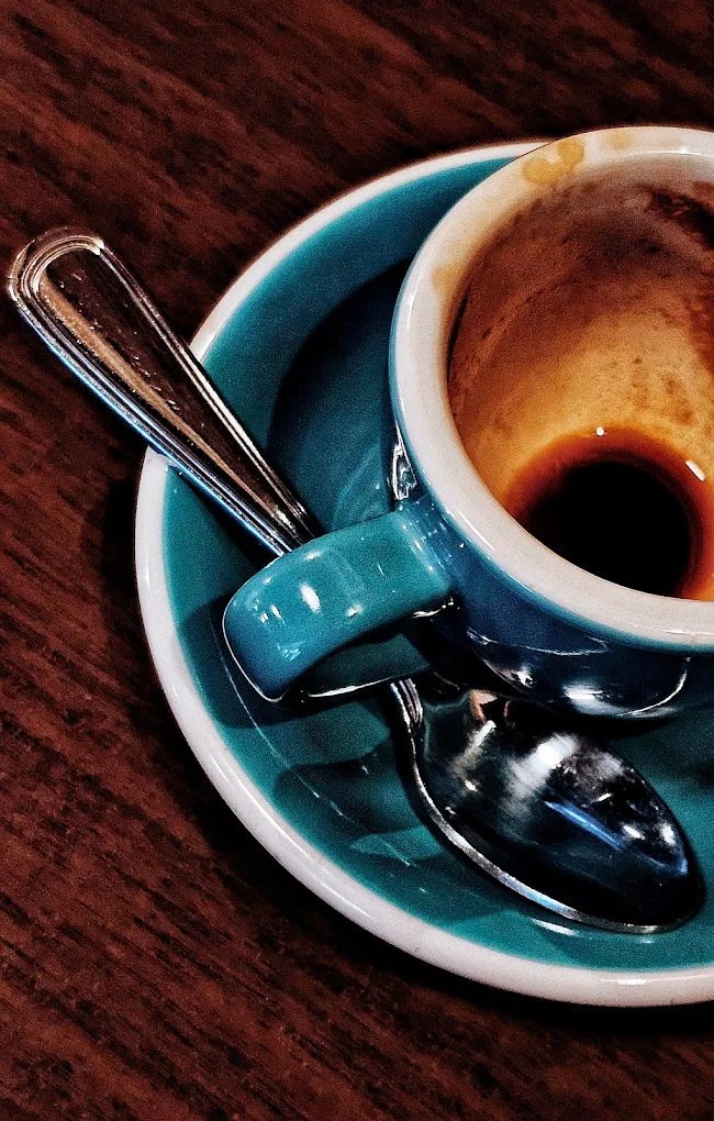 Espresso in Kaffa's signature teal cup with perfect crema